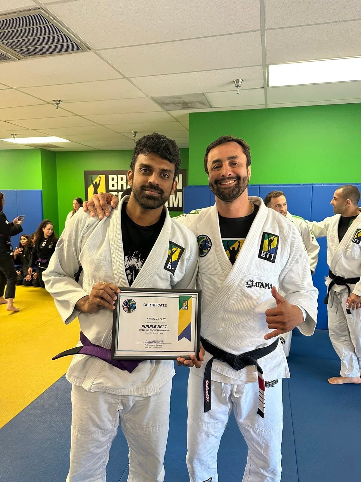 Krishna Peri receiving his purple belt from Professor Leonardo Machado at Brazilian Top Team